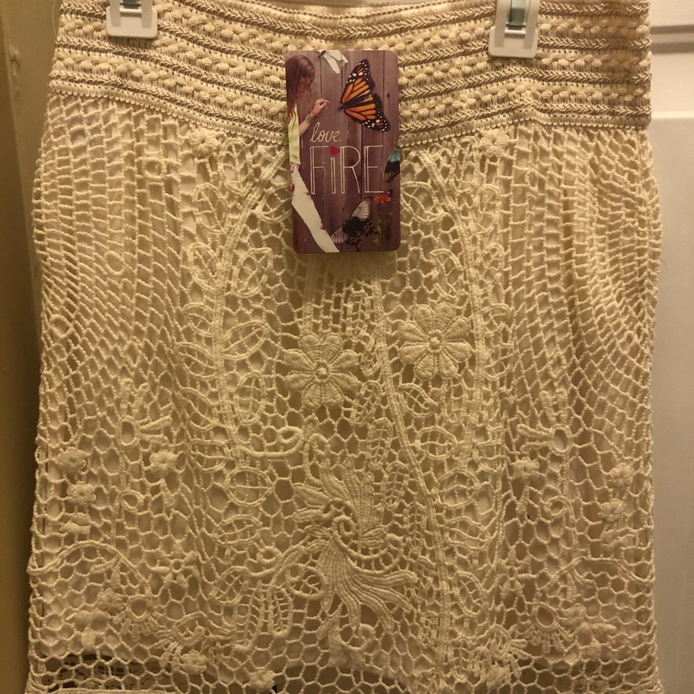 Cream colored lace skirt.